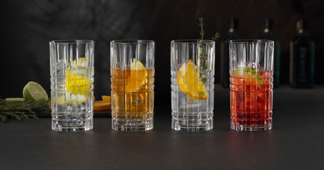 Four NACHTMANN Square longdrink glasses filled with different alcoholic and non-alcoholic drinks.<br/>