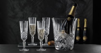 champagne flutes and champagne bottle in an ice bucket