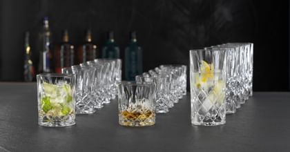 Six each of NACHTMANN Noblesse whisky tumblers, SOF, and long drink glasses, one glass of each type is filled